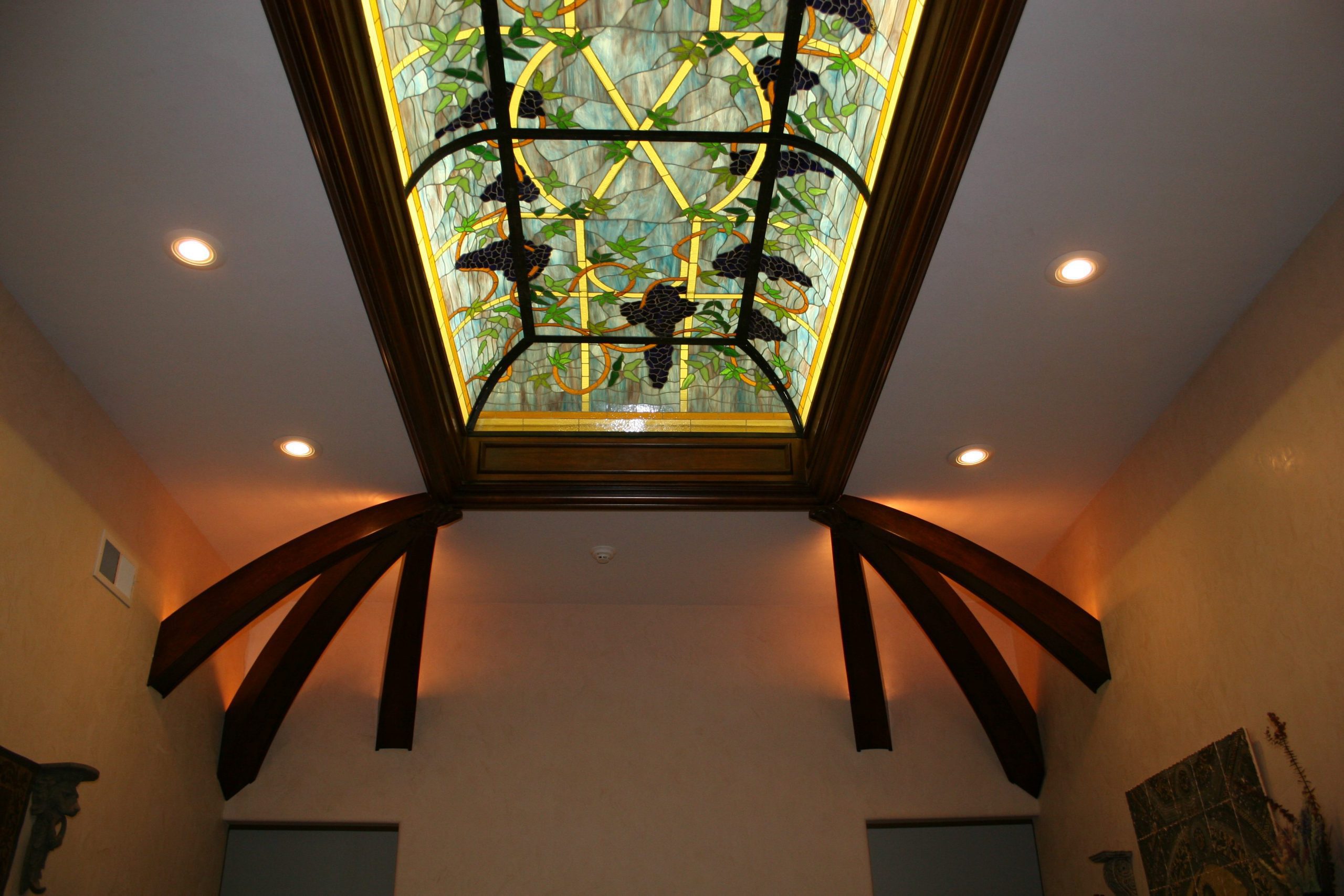 Decorative stained glass ceiling featuring colorful glass panels, architectural wood beams, and elegant interior craftsmanship in San Antonio, TX.